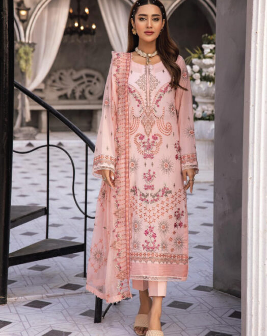 "Libass e Zeenat by AnayaHoor: A luxurious traditional outfit featuring a Swiss embroidered luxury lawn kameez in soft pink with intricate floral and geometric designs. The ensemble includes a matching bamber chiffon dupatta adorned with delicate embroidery and a pair of comfortable cambric cotton trousers. Perfect for special occasions, this elegant set combines traditional craftsmanship with modern elegance.